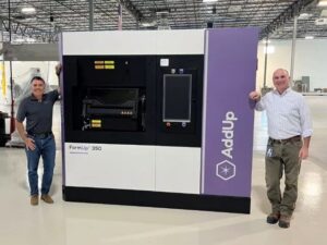 Greg Morris, CTO of Zeda, and Rush LaSelle, CEO of AddUp, stand next to the FormUp350 3D printing system.