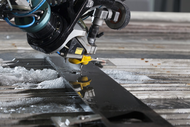 A Flow Mach 4c waterjet cutting carbon fiber. (Image courtesy of Flow International.)