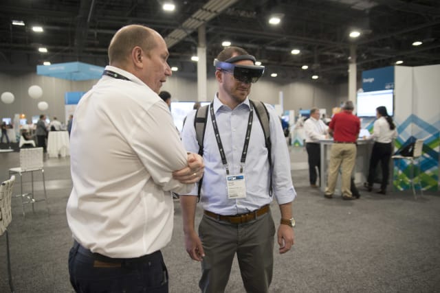 Another HxGN LIVE 2017 attendee tries out the HoloLens. (Image courtesy of Hexagon.)