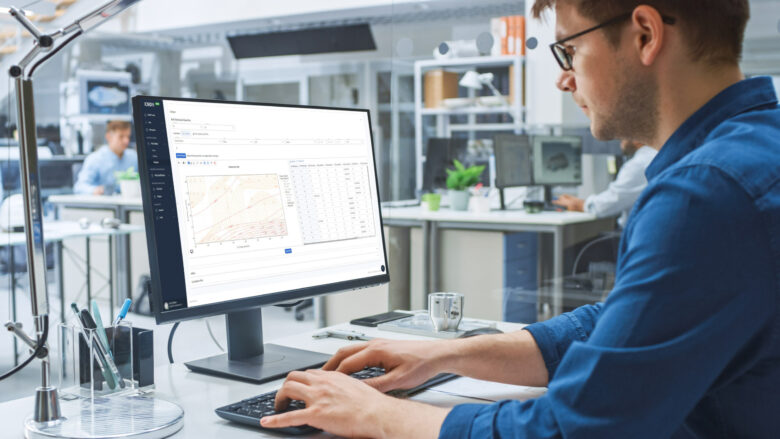 An engineer working on a laptop with QuesTek's ICMD digital materials design software.
