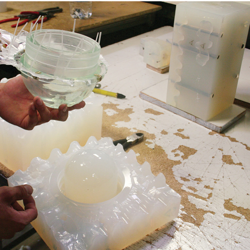 The clear nose cones on either end of NEMO were made first with a Stereolithography master pattern. This pattern was then used to form a silicone mold, which was cast with urethanes. The process allowed each thread to be cast directly into the nose cones, eliminating further machining. 