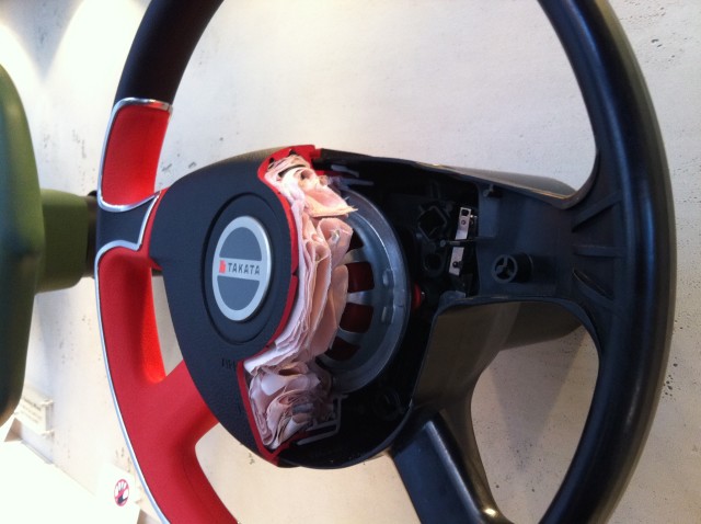 Folded Takata airbag inside a steering wheel hub.