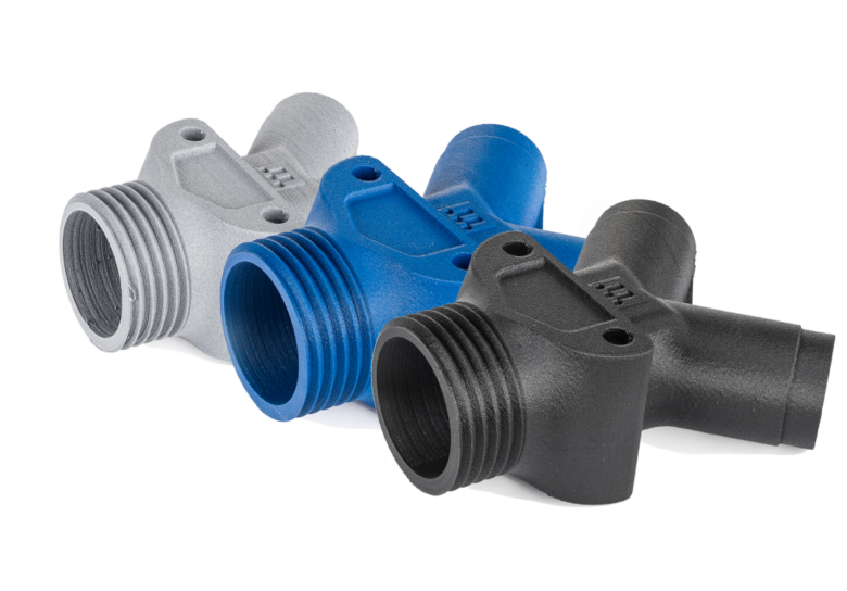 Three 3D-printed parts demonstrating Ultimaker's PET CF colors: gray, blue, and black.