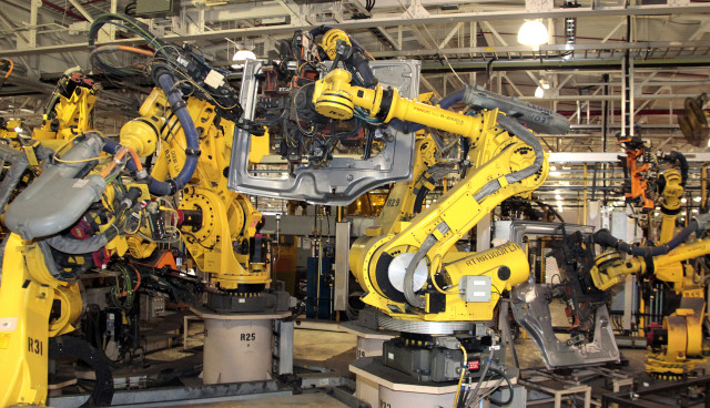 Robots at the FCA US Warren Stamping Plant assemble sliding doors for the Chrysler Town & Country and Dodge Grand Caravan. (Image courtesy of FCA.)